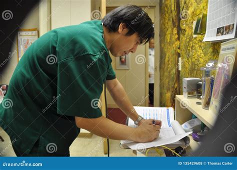 A Doctor Fills Out Some Paperwork Editorial Stock Photo Image Of