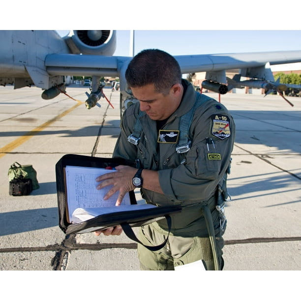 A Pilot Goes Over The Aircraft S Paperwork During His Preflight Checks