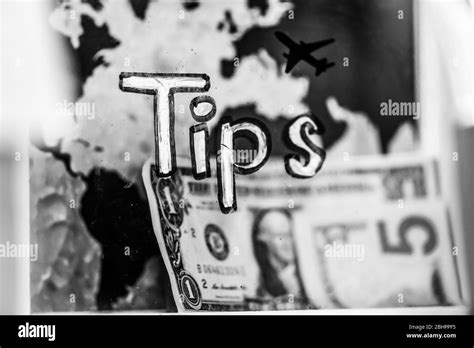 A Plastic Tip Jar With Five Dollar Bill In It On The Background Of A