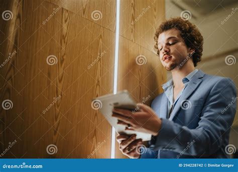 Architectural Team Inspecting And Discussing Project Details At Business Center Stock Photo