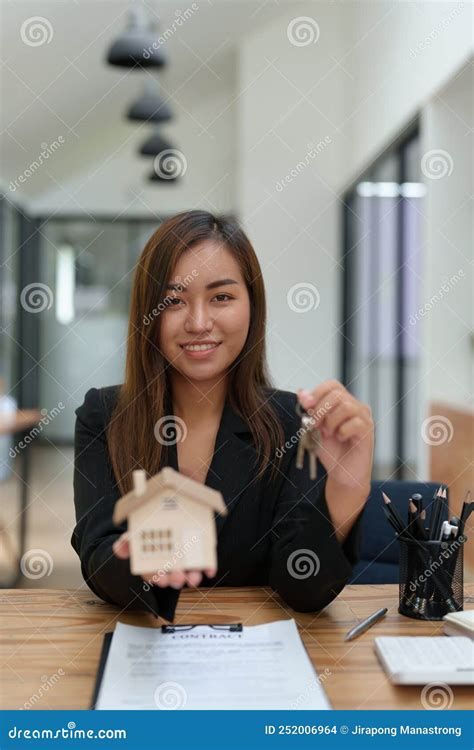 Asian Female Bank Employee Handing Over A House And Keys To A Client