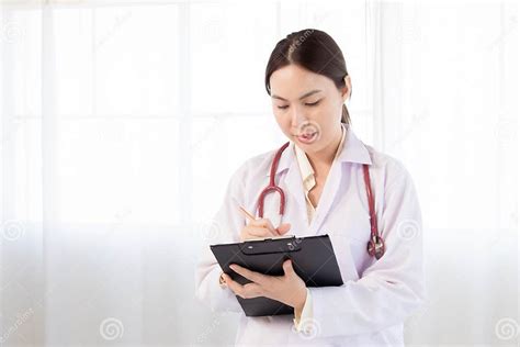 Beautiful Asian Woman Doctor Taking Note Information Of Patient In