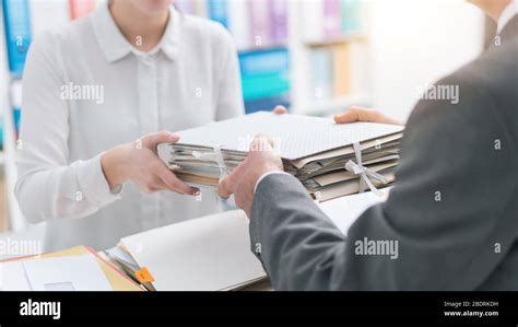 Boss Handing Paperwork To His Employee Stock Photo Image Of Bringing