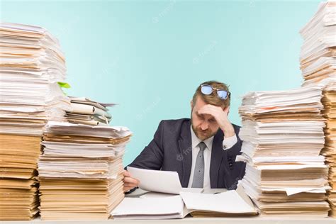 Business Executive Working In The Office And Piles Of Paperwork He Is