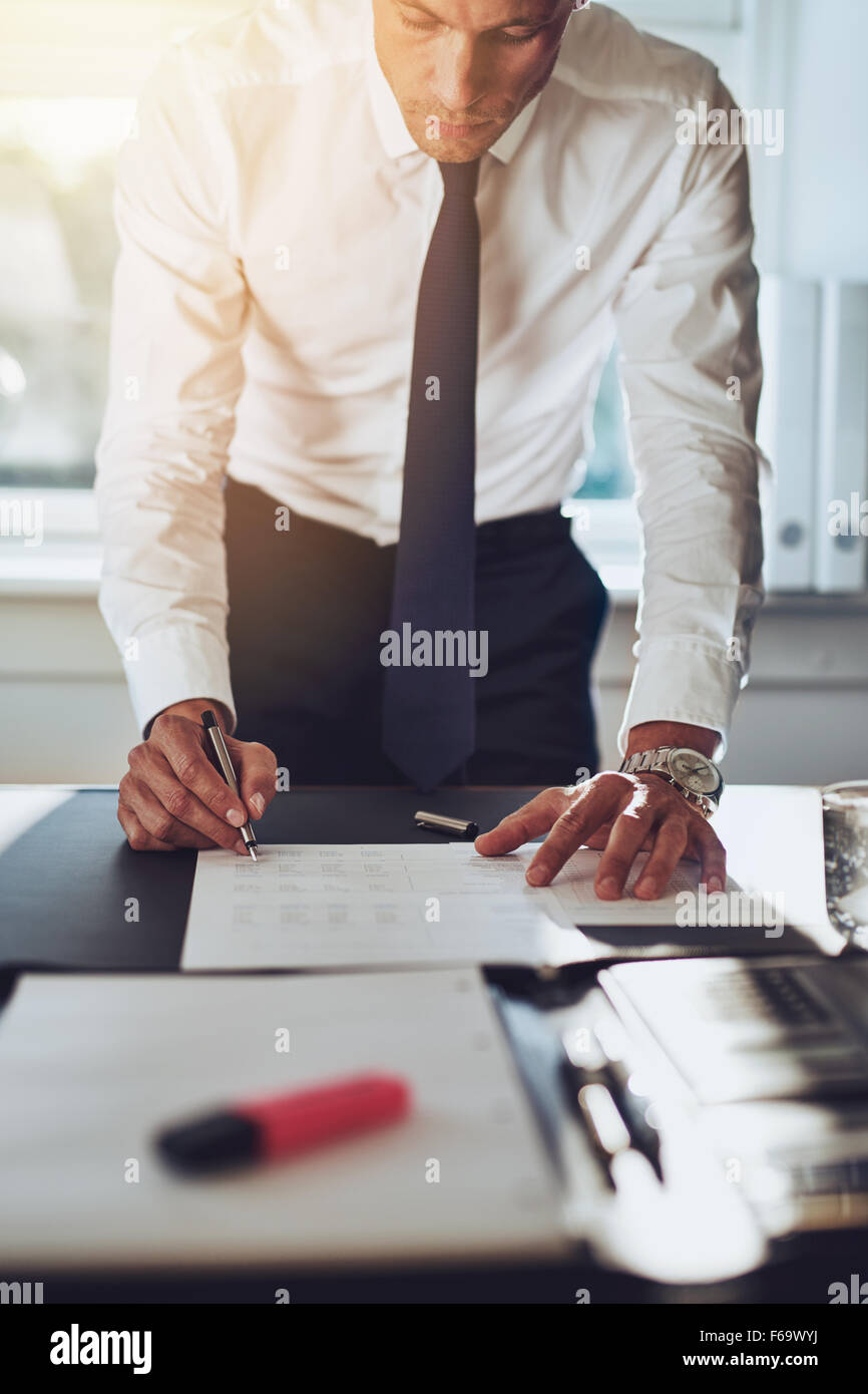 Business Man Closing A Deal Signing Documents At Desk In Office Wearing