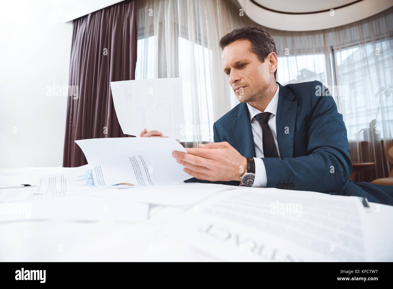 Businessman Reading Paperwork Stock Photo Alamy