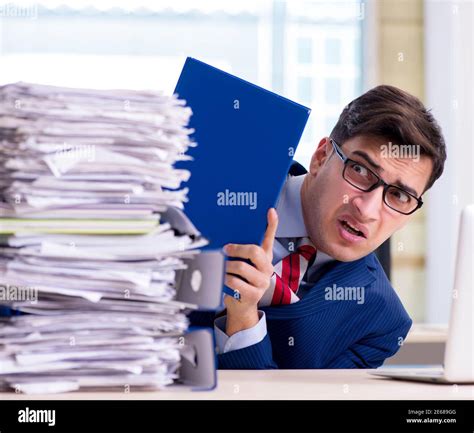 Businessman Workaholic Struggling With Pile Of Paperwork Stock Photo