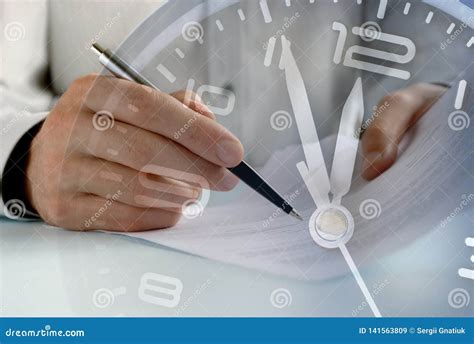 Businessman Working To A Deadline On Paperwork Stock Image Image Of Agreement Sign 141563809