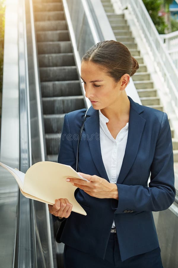 Catching Up With Work On Her Commute A Businesswoman Reading Paperwork