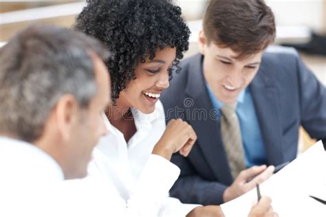 Checking Through Their Agenda A Diverse Group Of Businesspeople