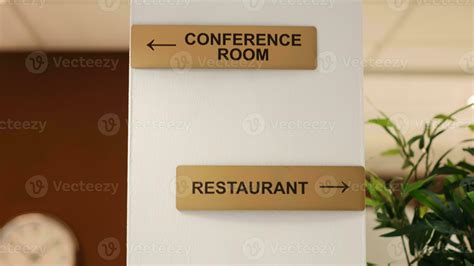 Close Up Of Hotel Facilities Plaques On Hotel Lounge Wall And Folders Of Tourist Accommodation