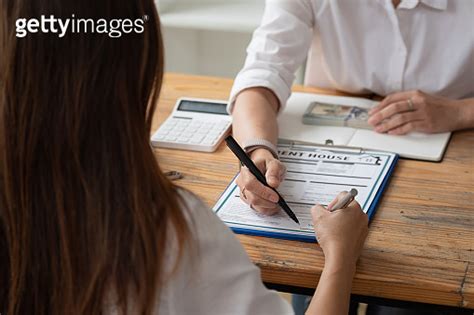 Close Up View Hands Of Businessman Signing Leasing Home Documents And