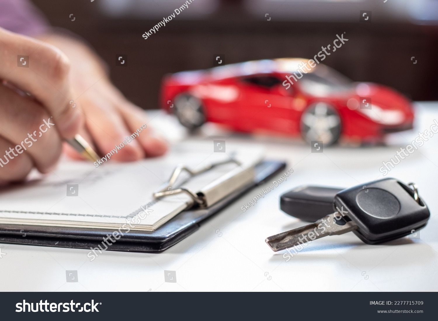 Closeup Of Asian Female Signing Car Insurance Document Or Lease Paper