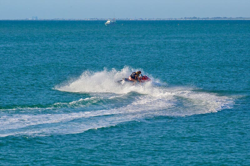 Closeup Side View Of A Senior Couple Riding A Jet Ski On A Sunny Health Boost Retirement