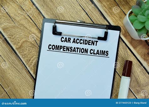 Concept Of Car Accident Compensation Claims Write On Paperwork Isolated On Wooden Table Stock