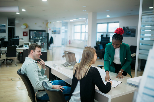 Couple Buying A New Car Signing Paperwork At Car Showroom High Res Stock Photo Getty Images