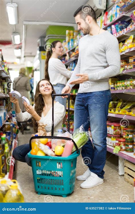 Couple Buying Groceries At A Supermarket Free Stock Photo