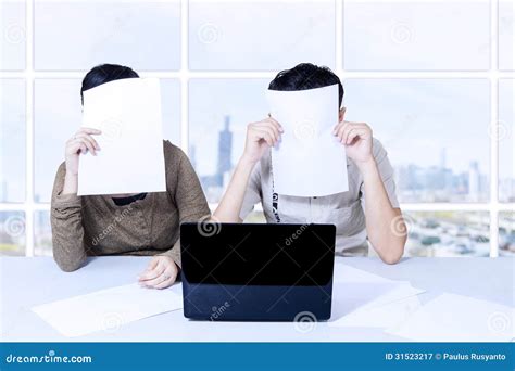 Couple Hiding Behind Papers Sitting With Laptop Royalty Free Stock Photography Image 31523217