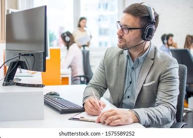 Customer Service Executive Doing Some Paperwork Stock Photo 1575589252