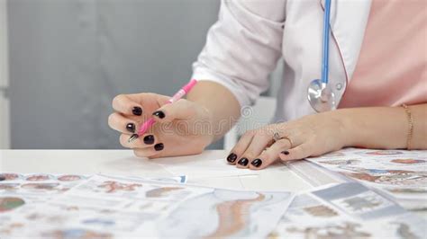 Doctor Doing Paperwork In Her Office Portrait Of Nurse Writing