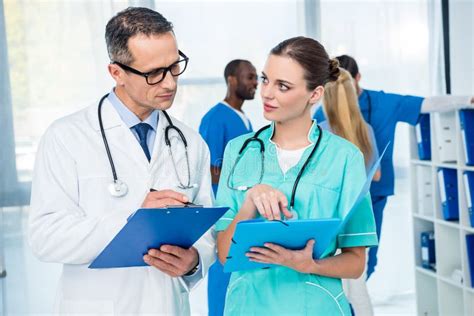 Doctors Doing Paperwork Together Stock Photo Image Of Safety Safe