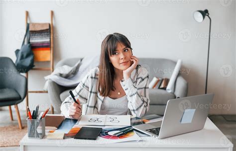 Doing Paperwork Young Female Freelance Worker Is Indoors In Home At