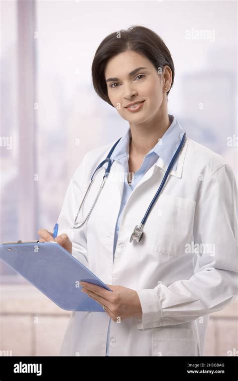 Female Doctor Doing Paperwork In Hospital Stock Photo Alamy