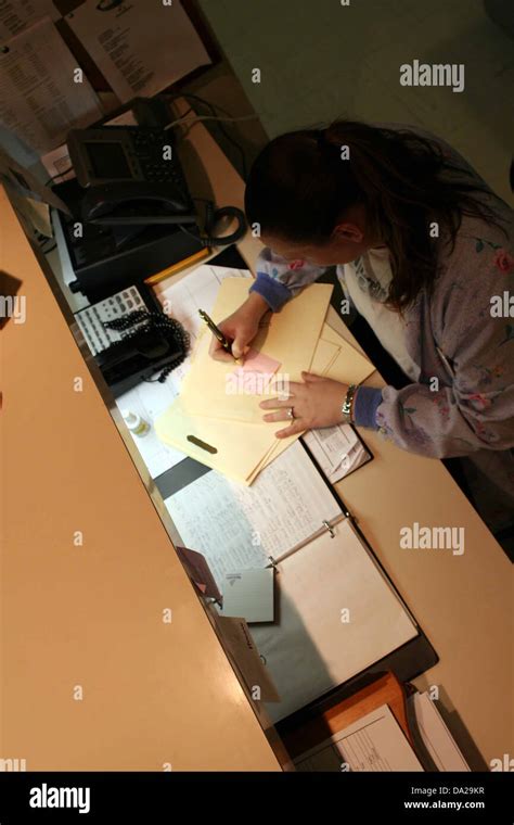 Female Woman Nurse Desk Paperwork Work Working Write Writing Medical