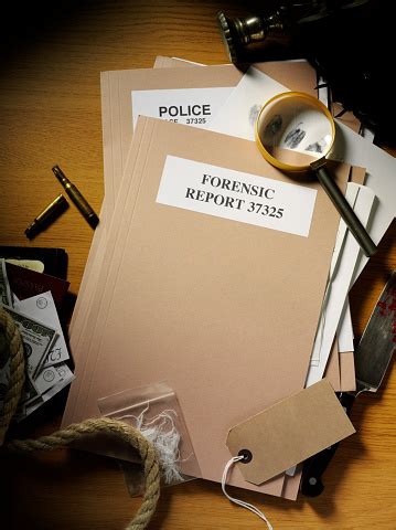 Forensic And Police Paperwork With Evidence From A Crime Stock Photo