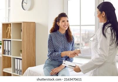 Friendly Nurse Helps Patient With Paperwork Stock Photo Download