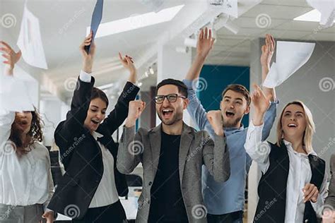 Group Of Business People Celebrating By Throwing Their Business Papers And Documents Fly In Air