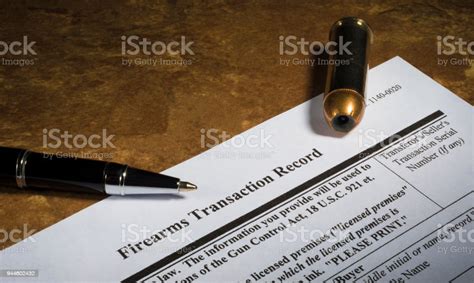 Gun Purchase Paperwork With A Pen And Cartridge 944602432