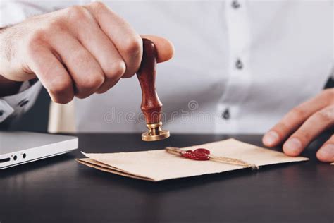 Male Attorney Stamping Document Seal On Notarized Paperwork Stock