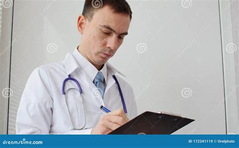 Male Doctor Doing Paperwork In The Office Stock Image Image Of