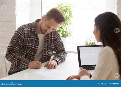 Male Employee Closing Successful Deal Signing Documents Stock Photo