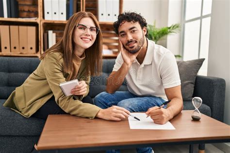 Man And Woman Having Psychology Session Writing On Paperwork At