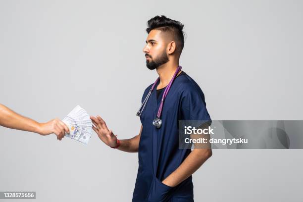 Man Giving Bribe To A Doctor Refusing The Money Isolated On White