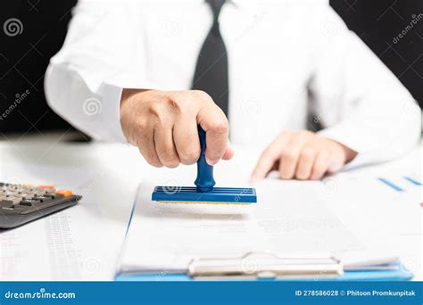 Man Hand Holding Stamp On Paperwork Or Document Finance Indoor At