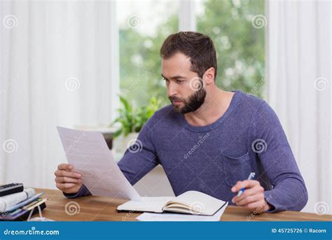 Man Sitting Doing Paperwork In A Home Office Stock Photo Image 45725726