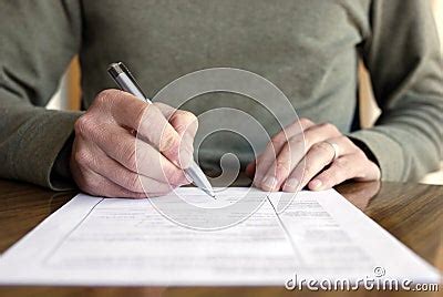 Man Writing On Paper With Pen On Table Stock Photo Image Of Sign