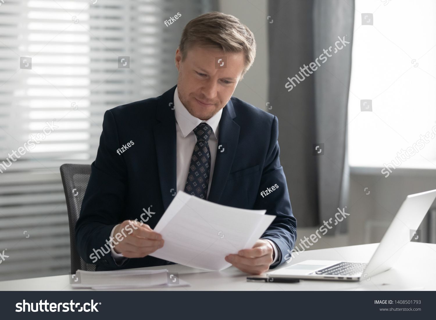 Mid Aged Business Man In Suit Holding Read Document Paper Report Sit At Office Desk Company Ceo