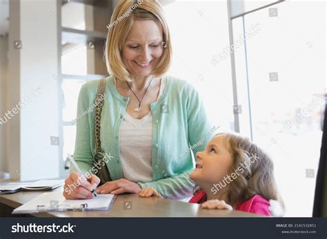 Mother Daughter Filling Out Paperwork Counter Stock Photo 2141532851