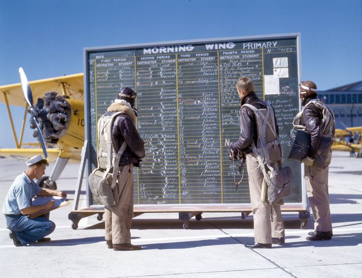 Naval Aviation Cadets Filling Out Paperwork On The Wing Of The Training Aircraft No Date At A