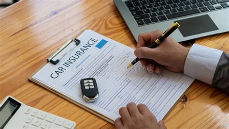 New Car Owner The Customer Signs The Insurance Paperwork Or Car Rental