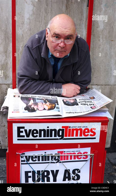 Newspaper Sales Man Selling Papers From A Street Corner Kiosk Argyll Street Glasgow Scotland