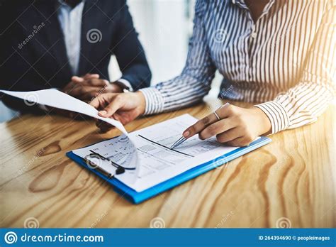 No Detail Gets Overlooked Closeup Shot Of Two Businesspeople Going Through Paperwork In An