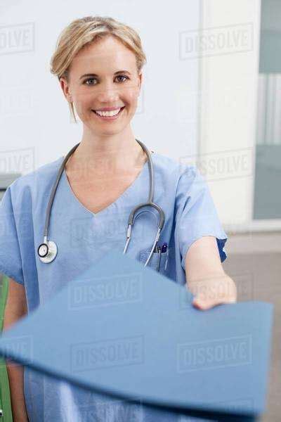 Nurse Handing Over Paperwork Stock Photo Dissolve