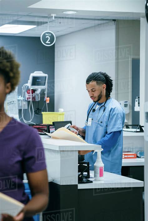 Nurse Scanning Paperwork In Hospital Stock Photo Dissolve