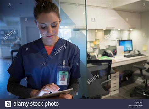 Nurse Using Digital Tablet At Nurses Station Stock Photo Image Of