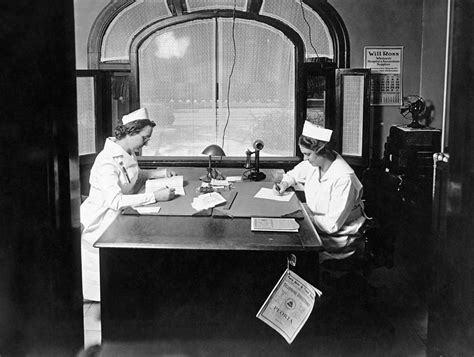 Nurses Doing Paperwork Photograph By Underwood Archives